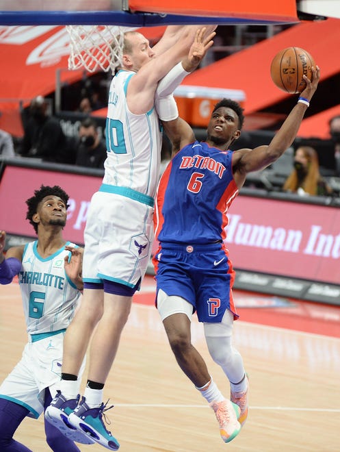 Pistons' Hamidou Diallo scores over Hornets' Cody Zeller in the fourth quarter.
