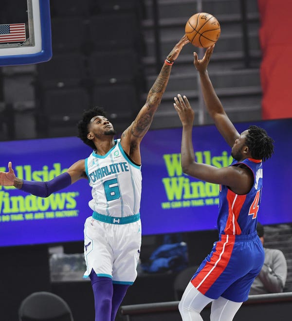 Detroit Pistons' Sekou Doumbouya scores over Charlotte Hornets' Jalen McDaniels in the first quarter of their game at Little Caesars Arena in Detroit, May 4, 2021.