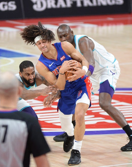 Detroit Pistons' Frank Jackson fights Charlotte Hornets' Brad Wannamaker for the ball in the second quarter of their game at Little Caesars Arena in Detroit, May 4, 2021.