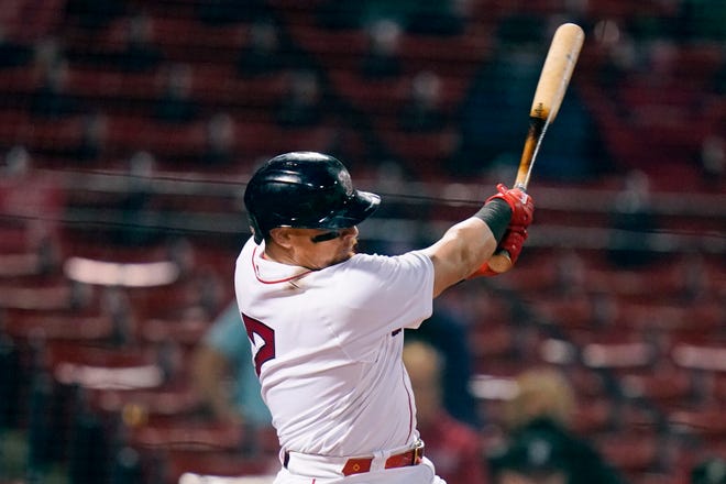 Boston Red Sox's Christian Vazquez follows through on his RBI double during the sixth inning.