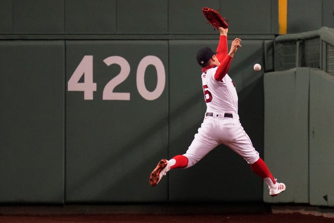 Boston Red Sox center fielder Enrique Hernandez leaps but can't make the play on an RBI double by Detroit Tigers' Robbie Grossman during the fifth inning.