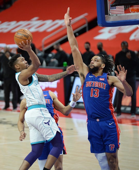 Pistons' Jahlil Okafor defends the shot of Hornets' Malik Monk in the first quarter.