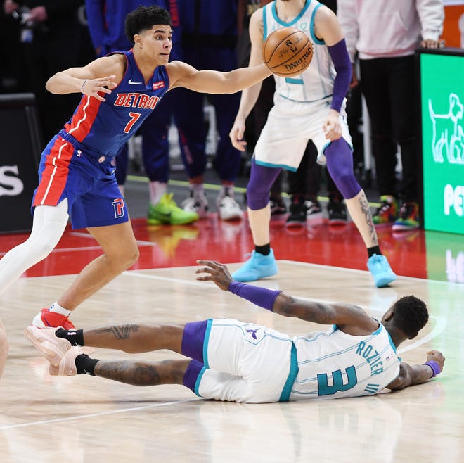 Pistons' Killian Hayes steals a pass from Hornets' Terry Rozier, (on floor), in the fourth quarter.
