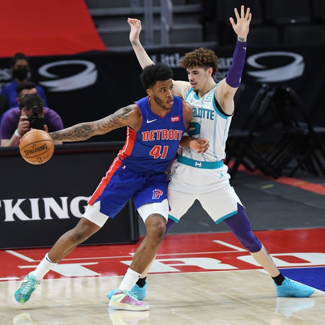 Detroit Pistons' Saddiq Bey looks for room around Charlotte Hornets' LaMelo Ball in the second quarter of their game at Little Caesars Arena in Detroit, May 4, 2021.