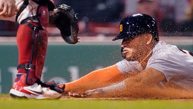 Detroit Tigers' Victor Reyes slides head first into home while scoring on an RBI double by Robbie Grossman during the fifth inning.