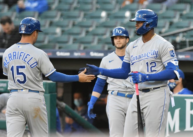 Royals right fielder Jorge Soler (12) congratulates Royals right fielder Whit Merrifield (15) after Merrifield scores in the first inning.