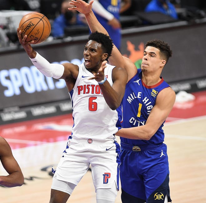 Pistons' Hamidou Diallo scores over Niggets' Michael Porter Jr. in the first quarter.