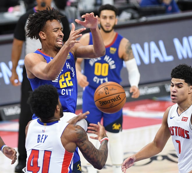 Pistons' Saddiq Bey knocks the away from Nuggets' Zeke Nnaji for a steal in the fourth quarter.