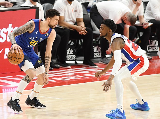 Pistons' Josh Jackson defends the Nuggets' Austin Rivers in the second quarter.