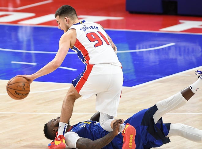 Pistons' Deividas Sirvydis collide with Nuggets' JaMychal Green in the third quarter and injured his left leg.