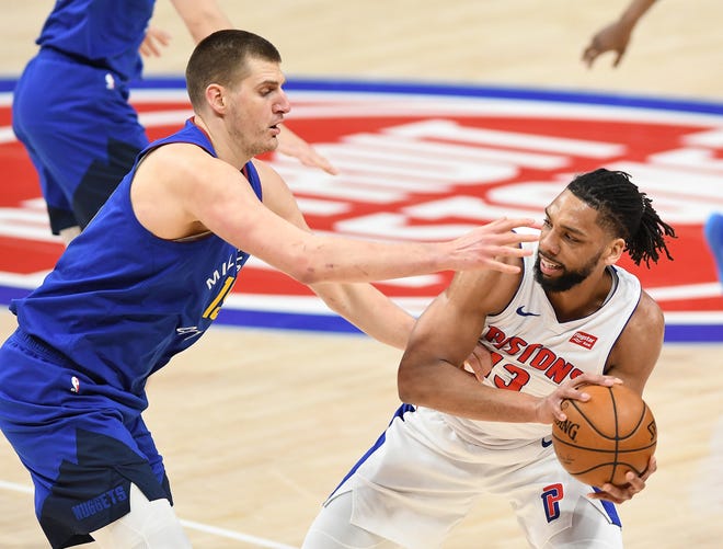 Pistons' Jahlil Okafor looks for room around Nuggets' Nikola Jokic in the first quarter.