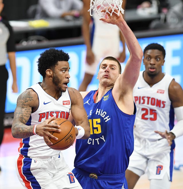 Pistons' Saddiq Bey makes a pass in front of Nuggets' Nikola Jokic in the first quarter.