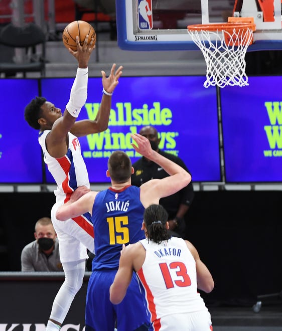 Pistons' Hamidou Diallo scores over Nuggets' Nikola Jokic in the third quarter.