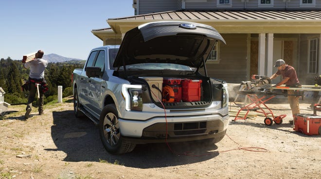 The F-150 Lightning XLT electric pickup truck features storage space under the hood.