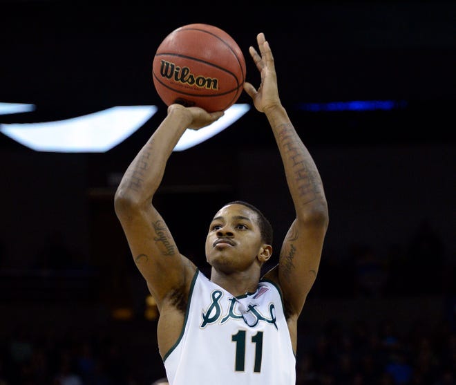 Michigan State's Keith Appling shoots a free throw during an 80-73 win over Harvard 80-73 at Spokane Arena in round three of the NCAA men's basketball tournament, March 22, 2014.