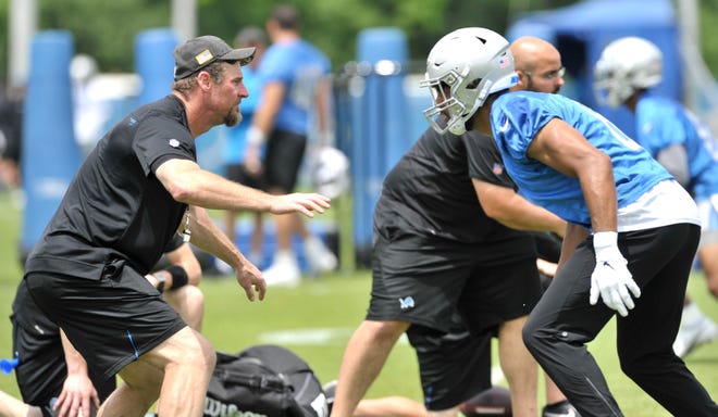 Head coach Dan Campbell, left, lines up against wide receiver Tyrell Williams (6) during a drill at practice.