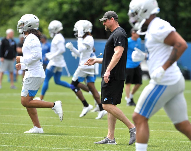 Lions head coach Dan Campbell spins his whistle during practice.