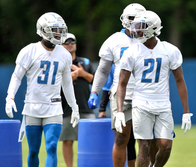 Lions safety Dean Marlowe (31) and defensive back Tracy Walker (21) talk during practice.