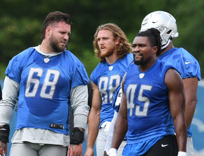 Detroit Lions tackle Taylor Decker, tight end T.J. Hockenson and fullback Jason Cabinda during a break in the action.