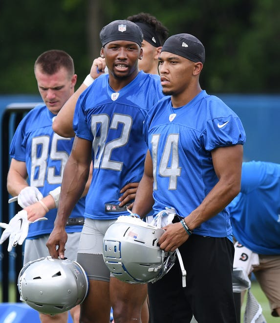 Detroit Lions rookie wide receivers Jonathan Adams (82) and Amon-Ra St. Brown (14) during a break in the action.