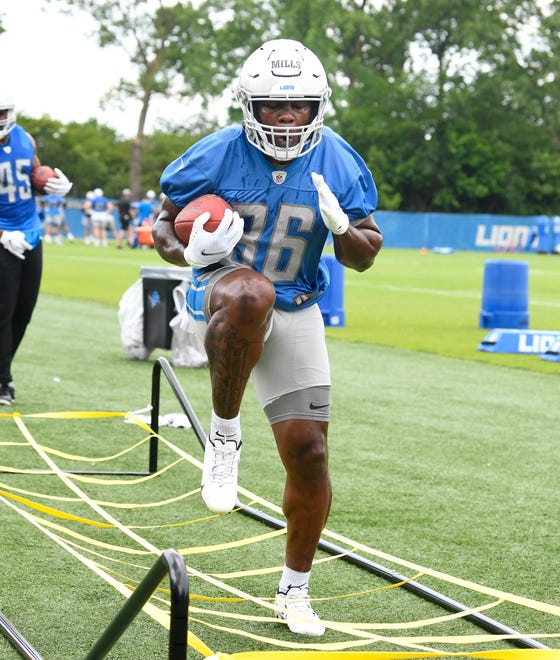 Lions rookie Lions running back Dedrick Mills works through the ropes during drills.