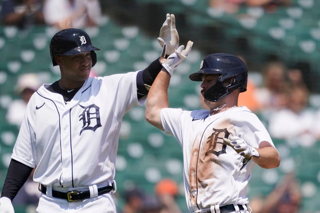 Detroit Tigers' Jonathan Schoop, left, greets Jake Rogers after Rogers scored during the fourth inning.