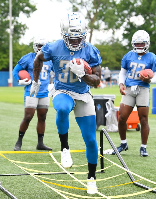 Lions running back Jamaal Williams works through the ropes during drills.