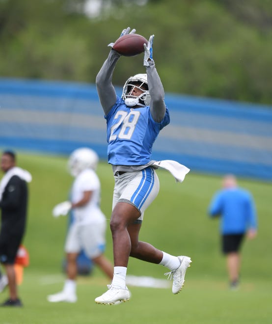 Lions running back Jermar Jefferson pulls in a reception during drills.