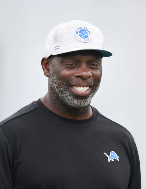 Lions offensive coordinator Anthony Lynn watches over his running backs during drills.
