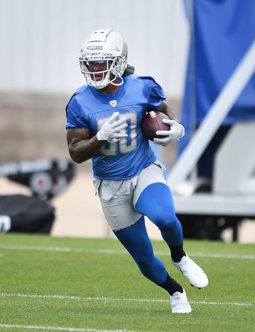 Lions running back Jamaal Williams heads up field after a reception during drills.