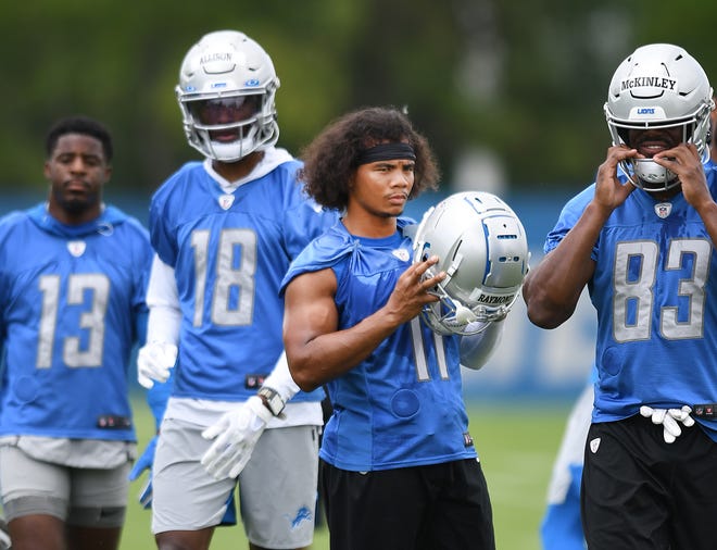 The Lions' Kalif Raymond and the wide receivers look on in between drills.
