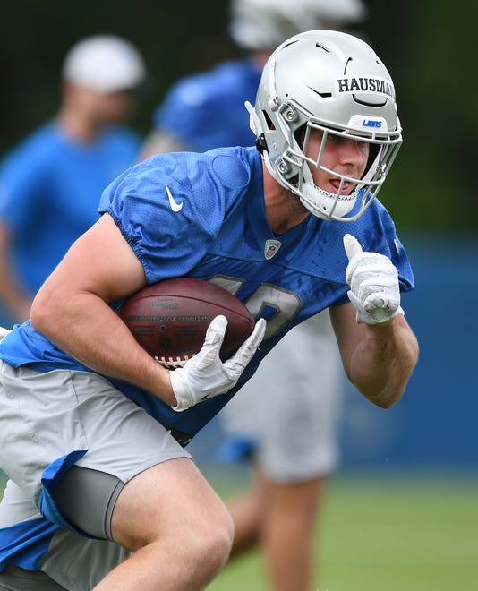 Lions rookie tight end Jake Hausmann heads up the field after a reception during drills.