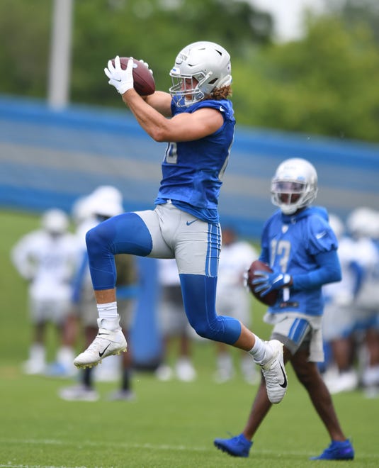 Lions tight end T.J. Hockenson pulls in a reception during drills.