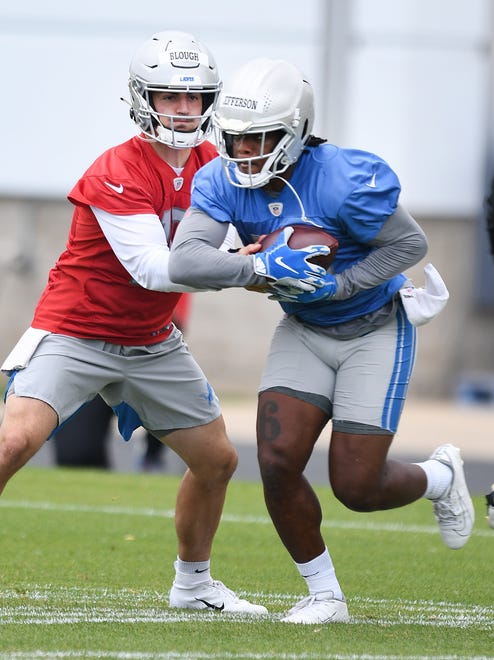 Lions quarterback David Blough hands off to rookie running back Jermar Jefferson during drills.