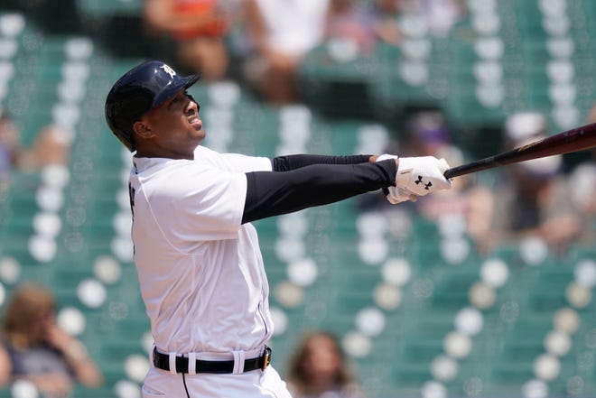 Detroit Tigers' Jonathan Schoop watches his solo home run clear the outfield fence during the first inning.