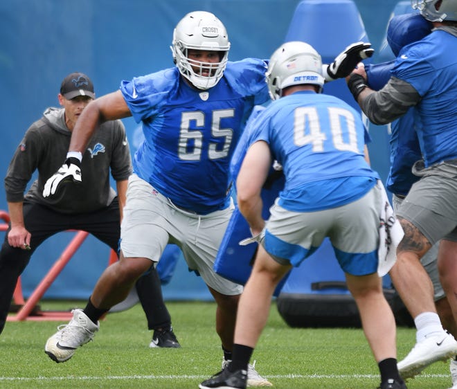 Lions offensive lineman Tyrell Crosby works during drills.