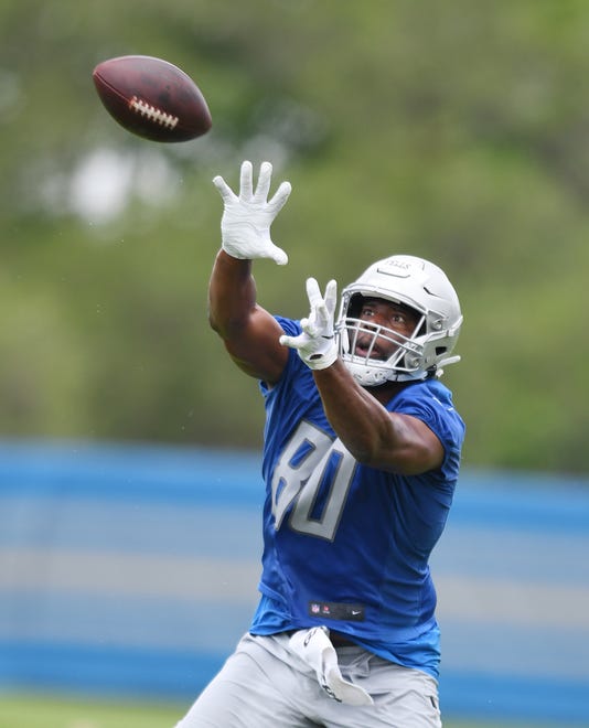 Lions tight end Darren Fells readies for a reception during drills.