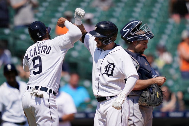 Detroit Tigers' Willi Castro greets Robbie Grossman next to Seattle Mariners catcher Tom Murphy after they scored on Grossman's two-run home run during the sixth inning on Thursday, June 10, 2021, at Comerica Park in Detroit.