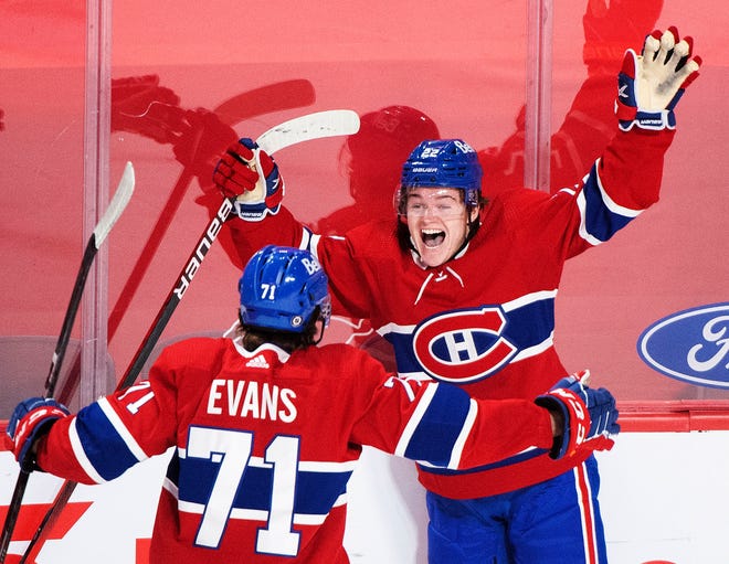 FILE - In this May 1, 2021, file photo, Montreal Canadiens' Cole Caufield (22) celebrates with teammate Jake Evans after scoring against the Ottawa Senators during overtime of an NHL hockey game in Montreal.