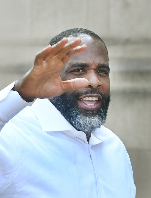 Former Detroit Mayor Kwame Kilpatrick waves to members of the media yelling out questions at Historic Little Rock Baptist Church in Detroit, Michigan, on June 13, 2021.