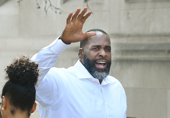 Former Detroit Mayor Kwame Kilpatrick waves to members of the media yelling out questions at Historic Little Rock Baptist Church in Detroit, Michigan, on June 13, 2021.