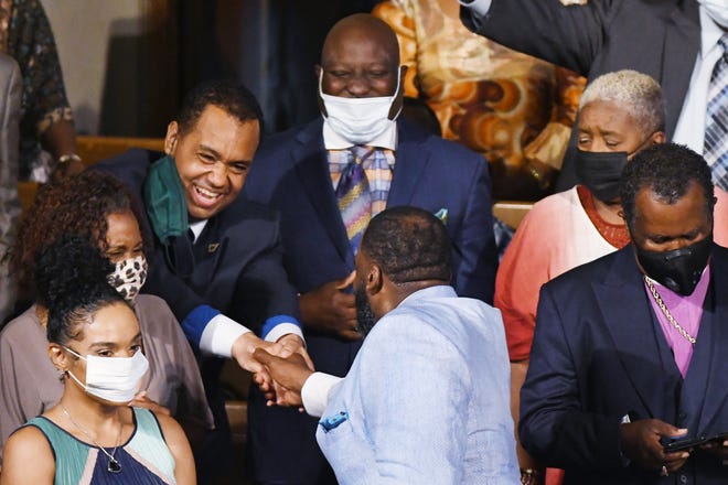 Former Detroit Mayor Kwame Kilpatrick shakes hands with members of the congregation after speaking at Historic Little Rock Baptist Church.