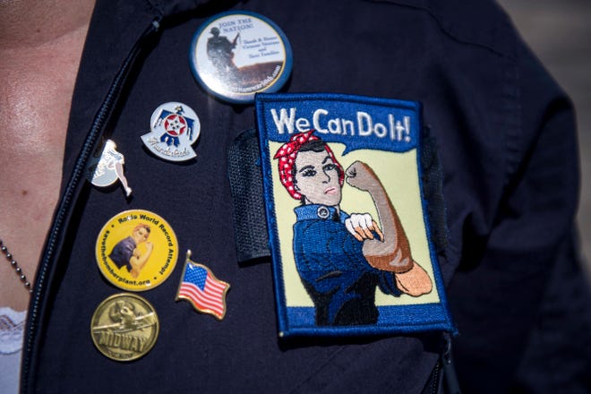 Michelle Brock of Chesterfield sports pins and patches of Rosie the Riveter.