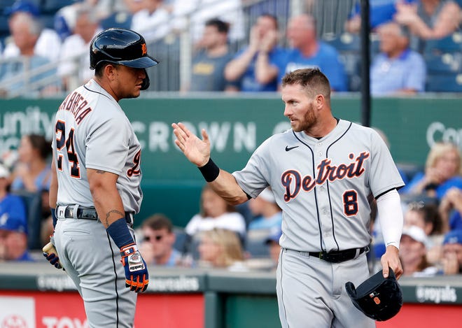 Tiger Robbie Grossman (8) is congratulated by teammate Miguel Cabrera (24) after scoring during the 1st inning.