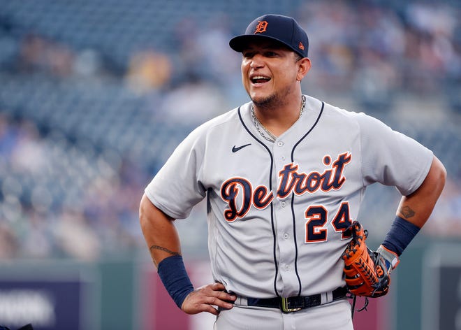 Tiger Miguel Cabrera (24) jokes with Kansas City Royals players during the game.