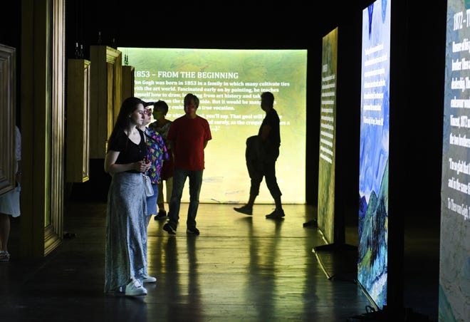 People walk through the Beyond Van Gogh exhibit during the first public day with more than 300 iconic artworks at the TCF Center in Detroit on Friday, June 25, 2021. Beyond Van Gogh uses cutting-edge projection technology to create an engaging journey into the world of Van Gogh.