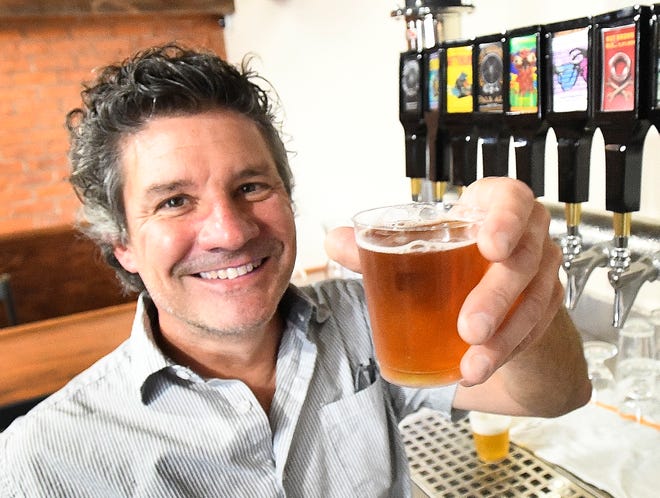 Motor City Brewing Works President and Founder John Linardos, with an India Pale Ale, during the Motor City Brewing Works opening on the "Avenue of Fashion" on Livernois, in Detroit, Michigan on July 12, 2021.