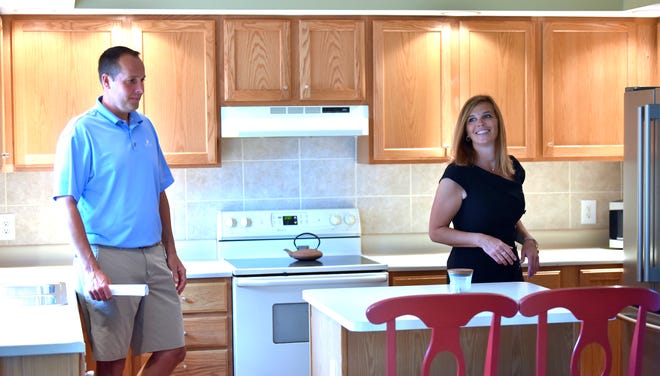 Sine and Monaghan Real Estate agent Danielle Boulier, right, of St. Clair Twp., shows off the kitchen in this Boulder Creek Condo in East China Twp., to Todd Carlson, of Clinton Twp., Thursday afternoon, July 15, 2021.
