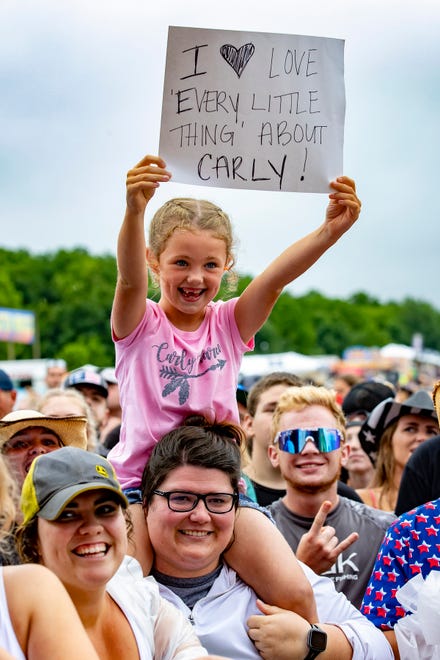 A young fan holds up her sign for country singer Carly Pearce during her performance at the Faster Horses music festival on July 16, 2021, in Brooklyn.