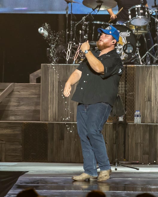 Luke Combs tosses the can after shot-gunning a beer during the Faster Horses music festival on July 16, 2021, in Brooklyn.